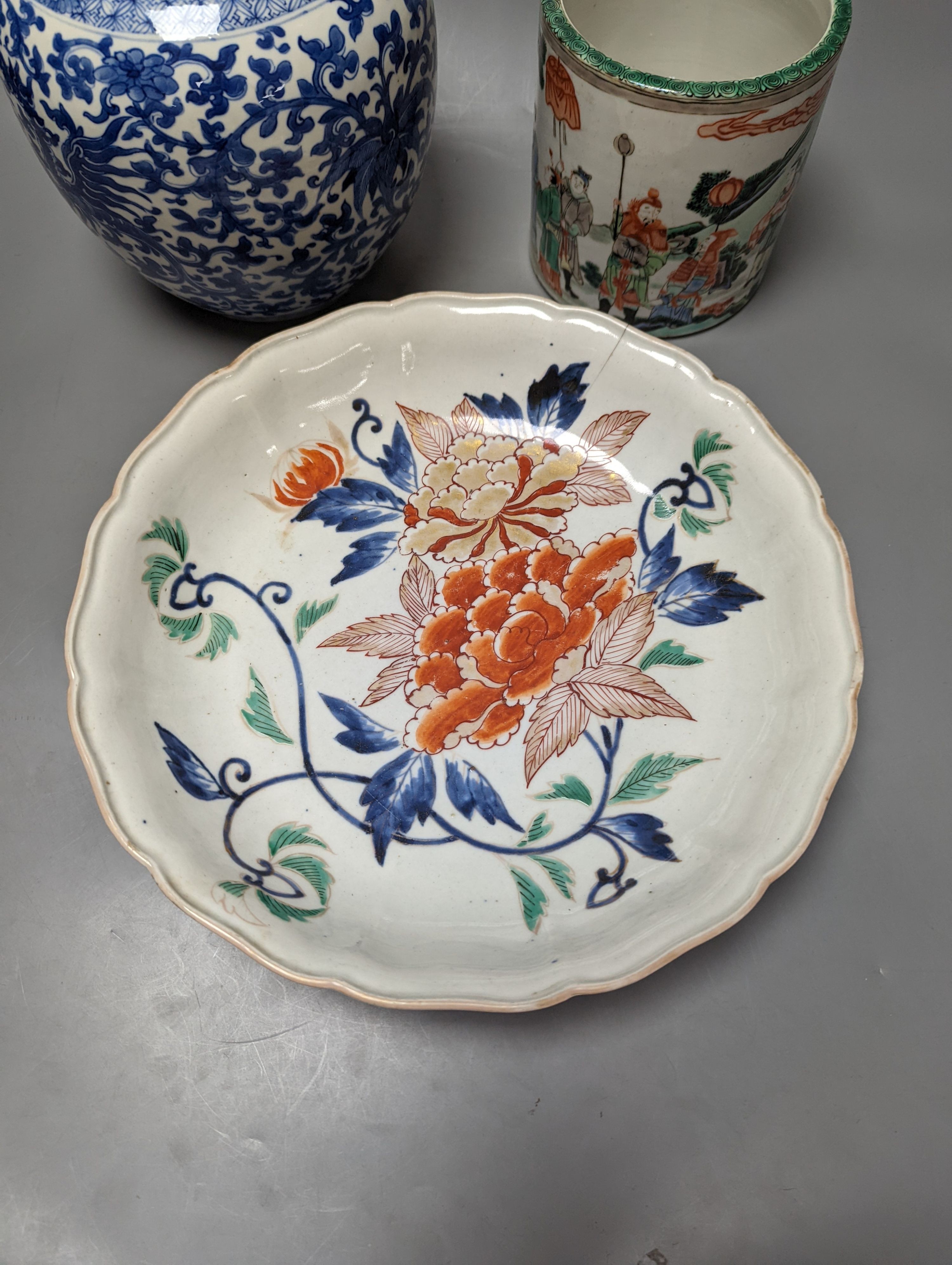 An Imari Japanese dish, a blue and white phoenix jar, and a famille verte brush pot with officials. Largest 29cm diameter